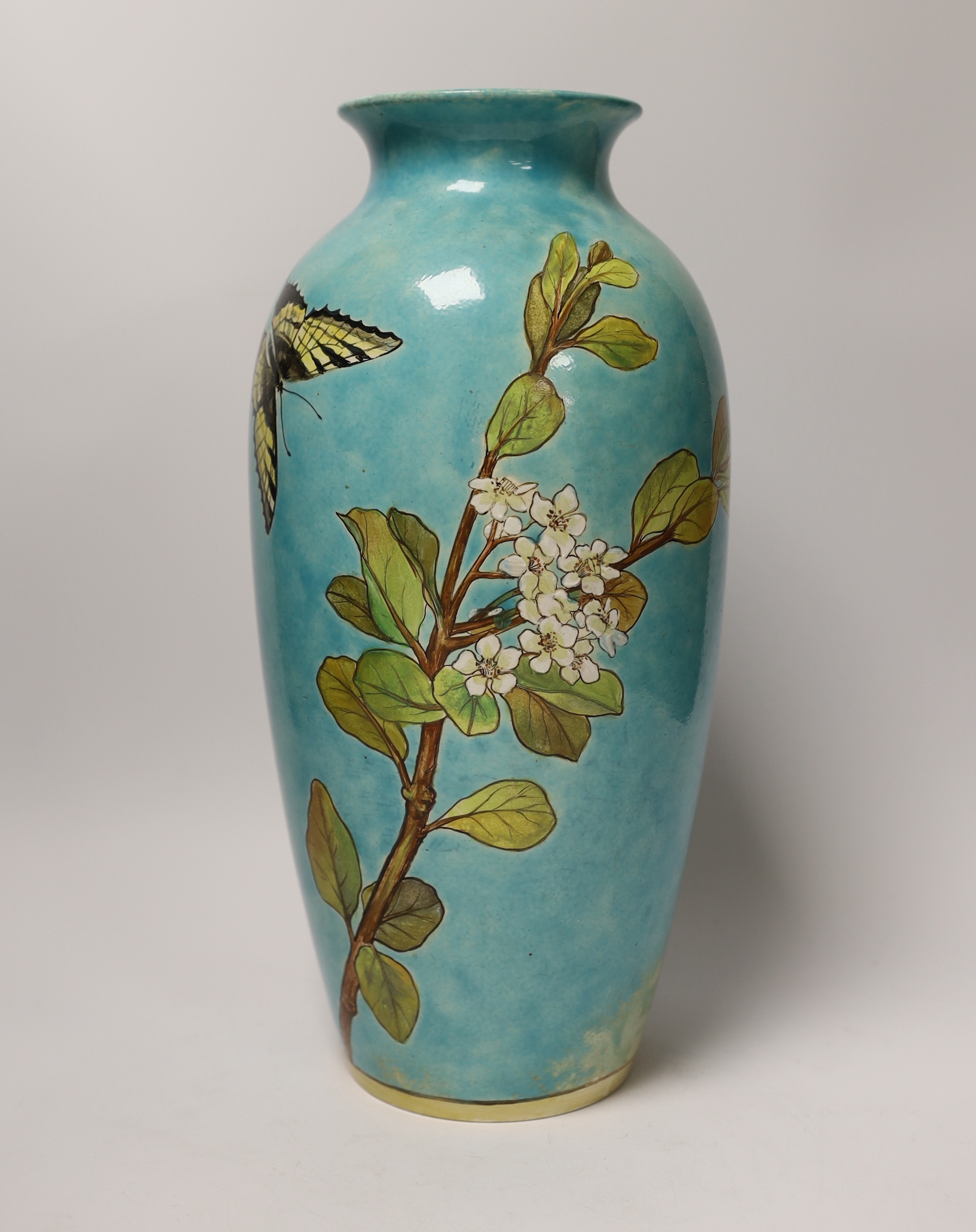 A Minton Art Pottery Studio Kensington Gore (1871-1875) vase, decorated with flowers and a butterfly, 35.5cm